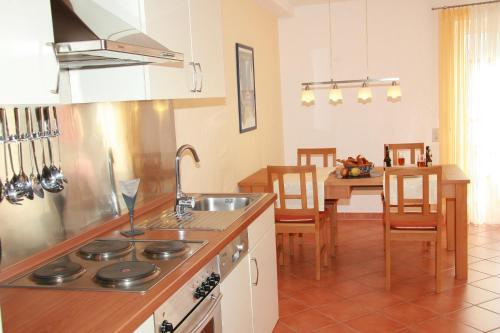 a kitchen with a sink and a stove top oven at Ferienwohnungen Holder in Anhausen