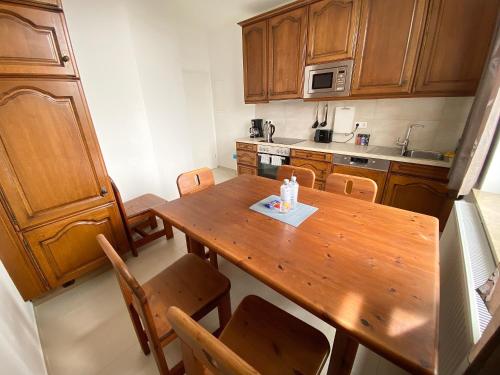 a small kitchen with a wooden table and chairs at 3 Rooms, free Parking, 25 min to Düsseldorf, 200 Mbps WLAN in Duisburg