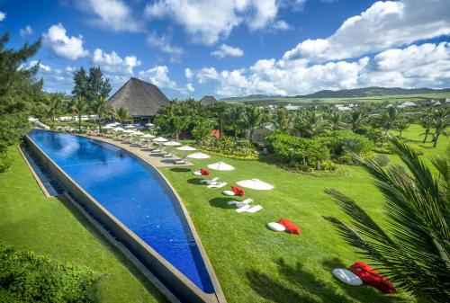 an aerial view of a resort pool with lounge chairs at SO/ Sofitel Mauritius in Bel Ombre