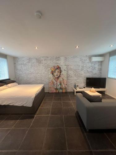 a bedroom with a bed and a couch at B&B Sloterpark in Amsterdam