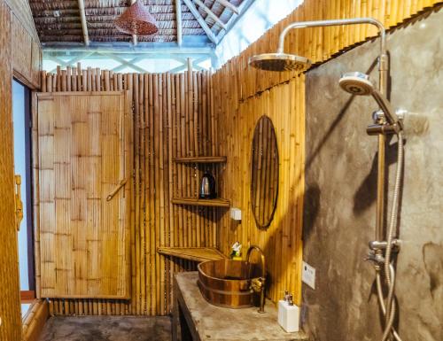 a wooden bathroom with a sink and a shower at Orion Healing Centre in Srithanu