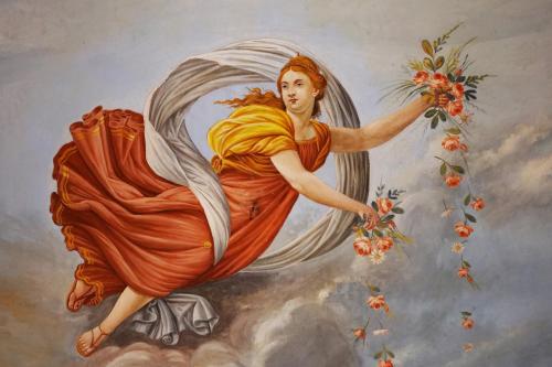 a painting of a woman holding a bouquet of flowers at Delcorto Suites in Montepulciano