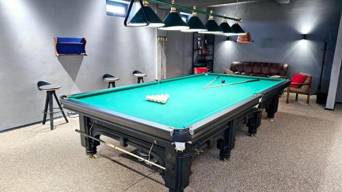 a pool table in a billiard room with at Alma Villa Guest House - Bosteri in Bosteri