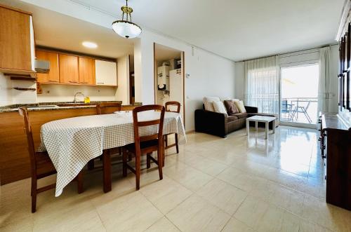 a kitchen and a living room with a table and chairs at BOOK VILA-SECA TOWN in Vilaseca de Solcina