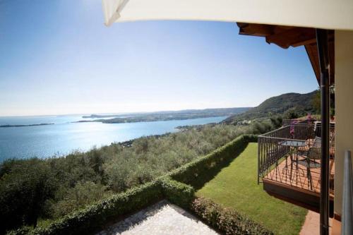 a view of the water from the balcony of a house at Agriturismo Il Casale Del Lago in Gardone Riviera
