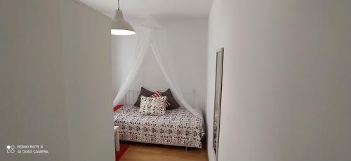 a small bedroom with a bed with a canopy at Caracol Trail Mountain La Palma junto a Trebol in Tazacorte