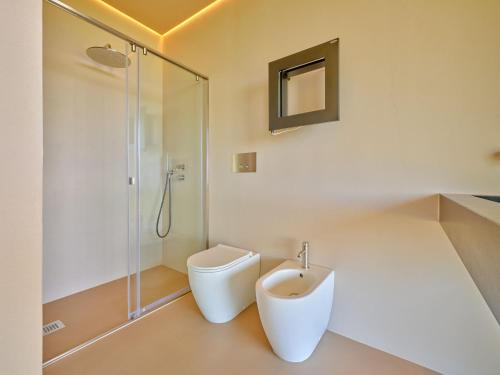 a bathroom with a toilet and a shower at VillasGarda - Villa Bardolino in Bardolino