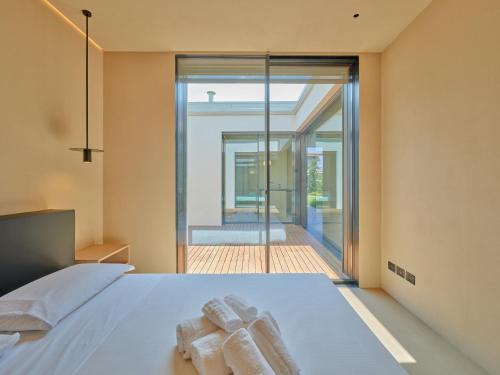 a bedroom with a bed with two towels at VillasGarda - Villa Bardolino in Bardolino