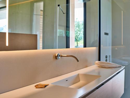 a bathroom with a sink and a mirror at VillasGarda - Villa Bardolino in Bardolino