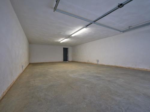 an empty room with a concrete floor and a white wall at VillasGarda - Villa Bardolino in Bardolino