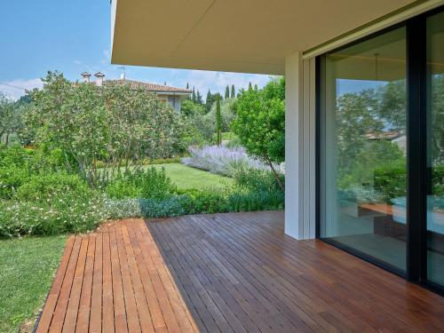 a house with a glass door and a patio at VillasGarda - Villa Bardolino in Bardolino