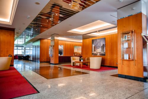 a lobby with chairs and a table in a building at Müggelseeperle in Berlin