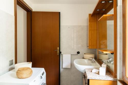 a bathroom with a sink and a toilet and a sink at LEONI Apartment - charming full home in Bellagio in Bellagio