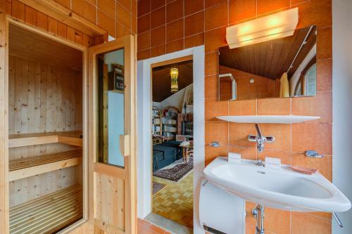 a bathroom with a sink and a mirror at Casa Dell'Antonio - Happy Rentals in Aranno