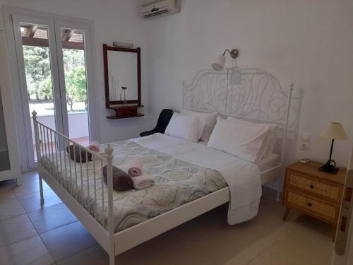 a bedroom with a crib with a baby laying on it at Lemontree Apartments in Kassiopi