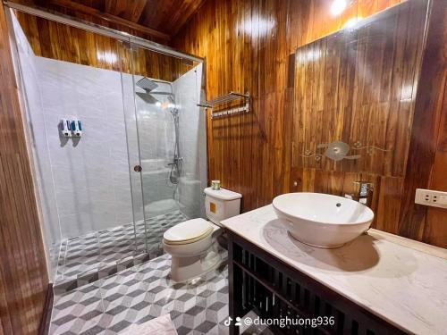 a bathroom with a shower and a toilet and a sink at Villa Phathana Royal View Hotel in Luang Prabang