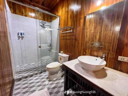 a bathroom with a shower and a toilet and a sink at Villa Phathana Royal View Hotel in Luang Prabang