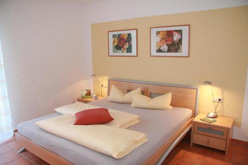 a bedroom with a bed with two pillows on it at Ferienwohnungen Holder in Anhausen