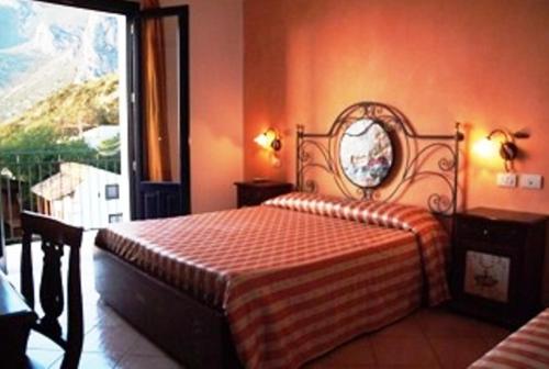 a bedroom with a bed with a mirror on the wall at Torre Salina in Macari