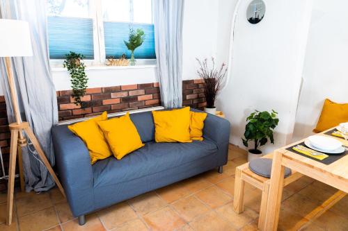 a blue couch with yellow pillows in a living room at Spacious Apartment in urban location in Hamburg