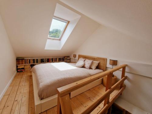 a bedroom with a large bed with a window at Apartmán Singer in Banská Štiavnica