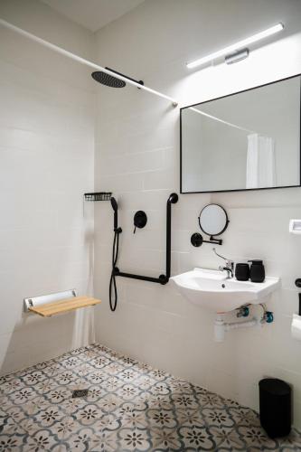 a bathroom with a sink and a mirror at כפר הנופש קיבוץ גדות Kibbutz Gadot Galilean Resort in Gadot