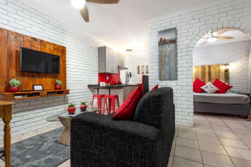 a living room with a couch and a kitchen at Rozelee Rest 1 in Nelspruit