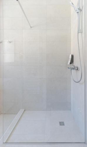 a bathroom with a shower with a glass door at Stay Swanky Bed & Breakfast in Zagreb