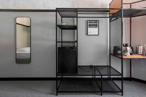 a black bunk bed with a mirror and a desk at Stay Swanky Bed & Breakfast in Zagreb