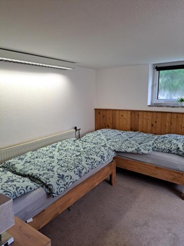 a bedroom with a large bed and a window at Apartment Kastanienallee Rosenthal in Berlin