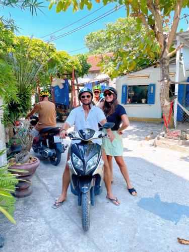 a man and a woman on a motor scooter at Hammock Homestay in Tân Hiệp