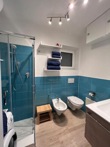a bathroom with a shower and a toilet and a sink at La casa di Camilla in Cannigione