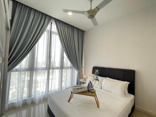 a bedroom with a bed and a large window at D'pristine by Antlerzone in Johor Bahru