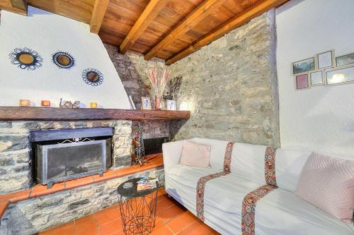 a living room with a couch and a fireplace at Rustico Romantico Brè - Happy Rentals in Lugano