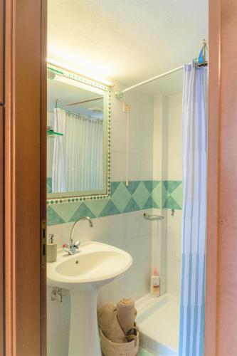 a bathroom with a sink and a shower at Cretan Experiences in Agia Pelagia