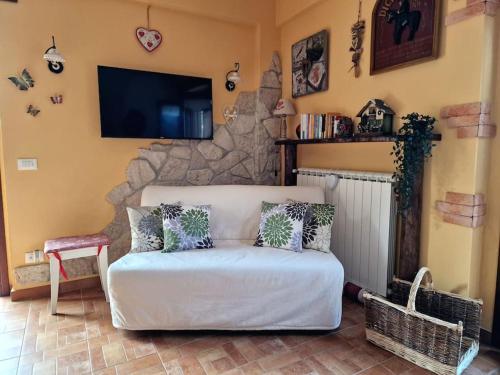 a living room with a bed and a tv at La Libellula apartment (Il tuo Chalet sul colle) in Castel di Sangro