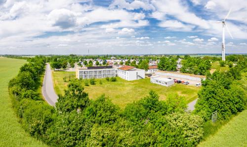 an overhead view of a building with a wind turbine at Dresdner Tor Süd in Wilsdruff