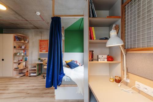 a bedroom with a bed and a desk in a room at Chillout Dorm Cracow by BookingHost in Krakow