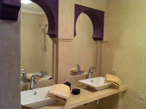 a bathroom with two sinks and a large mirror at Villa Marrakech in Marrakesh