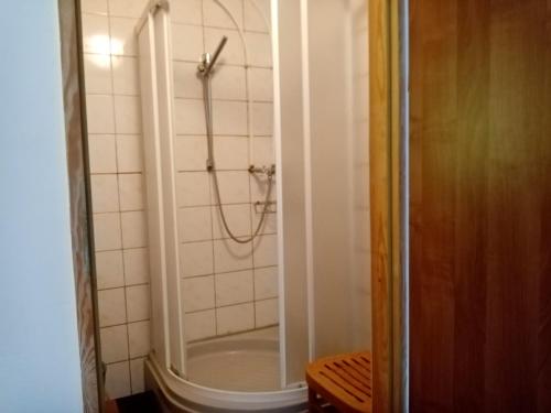 a bathroom with a shower and a tub at Agroturystyka Camp4x4 in Nosów