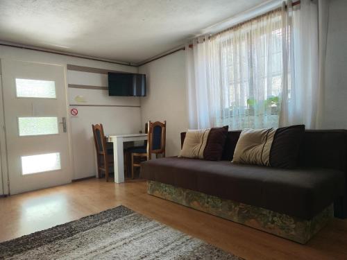uma sala de estar com um sofá e uma mesa em Snezana home em Vranje
