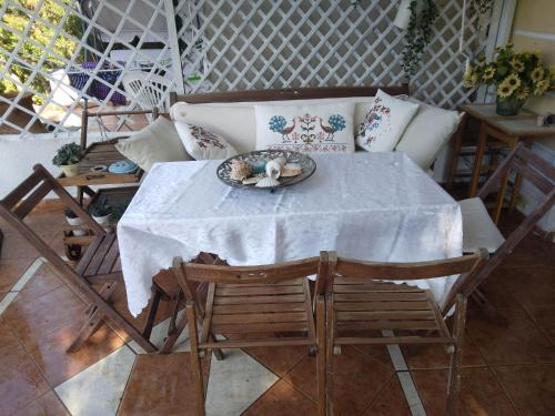 a table and chairs with a plate of food on it at Villa Gerakina in Gerakini