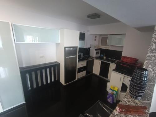 a small kitchen with black and white appliances at Central Apartments in Bucharest