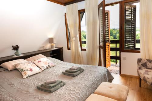 a bedroom with a bed with two towels on it at Casa Madera in Karlovac