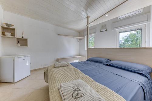 a bedroom with a blue bed and a window at Villa Gianna in Casarano