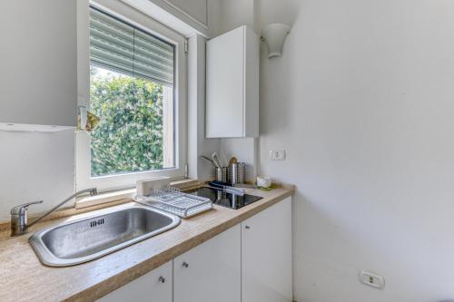 a kitchen with a sink and a window at Villa Gianna in Casarano