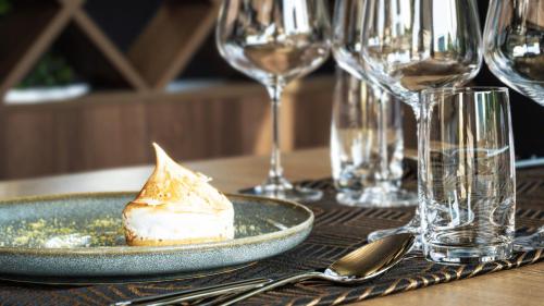a plate of dessert on a table with wine glasses at Admiral Hotel in Zagreb