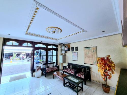een woonkamer met banken en een groot raam bij Hotel Taman Sari in Jakarta