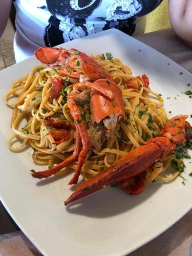 a plate of food with shrimp and pasta at Portorosa in Torre Forte
