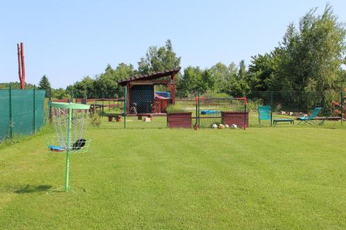 a park with a frisbee golf hoop in the grass at Dřevěný anděl in Lodhéřov